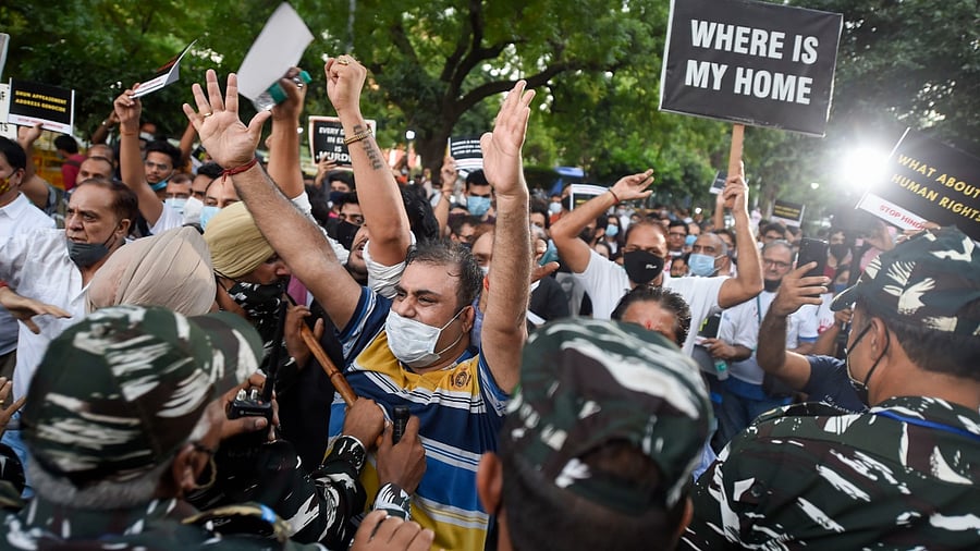 People from the Kashmiri Hindu community clash with security personnel during their protest rally to express their anguish over free run of terrorist activities in the Kashmir valley. Credit: PTI Photo