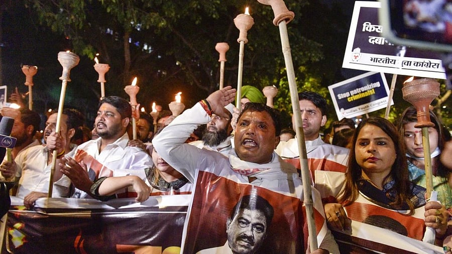 Indian Youth Congress (IYC) activists carry out 'Mashal Aakrosh Julus' from IYC headquarters to Jantar Mantar, demanding justice for the Lakhimpur Kheri violence victims and suspension of Union MoS for Home Affairs Ajay Kumar Mishra, in New Delhi. Credit: PTI Photo