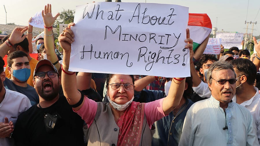 Kashmiri pandits shout slogans and block Tawi Bridge during a protest after militants shot dead two teachers in Srinagar's Eidgah Sangam. Credit: PTI Photo
