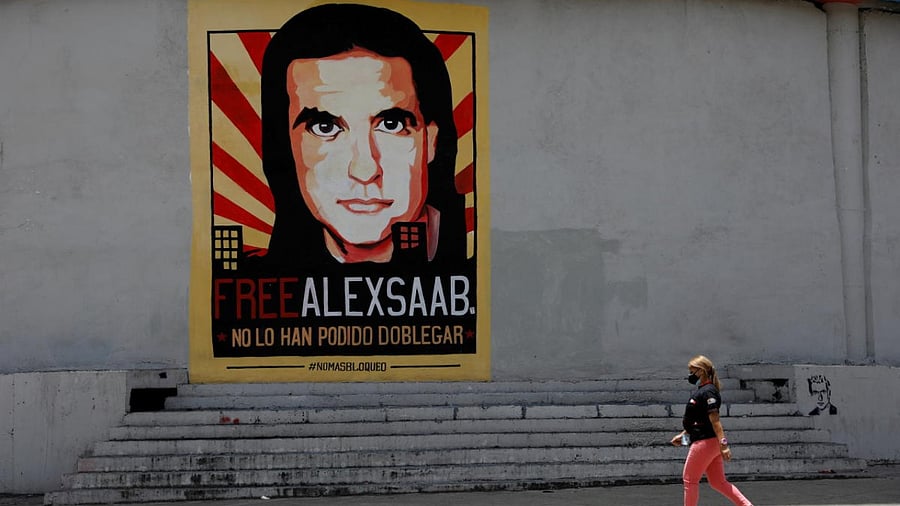  A woman walks by a mural in support of the liberation of businessman Alex Saab, who was detained in Cape Verde on charges of laundering money for the government of Venezuelan President Nicolas Maduro. Credit: Reuters File Photo