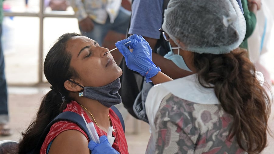 Swab tests to passengers arriving at the BMTC bus stand, after the Karnataka government eased restrictions for travel amid ongoing Coronavirus pandemic. Credit: DH Photo/Pushkar V
