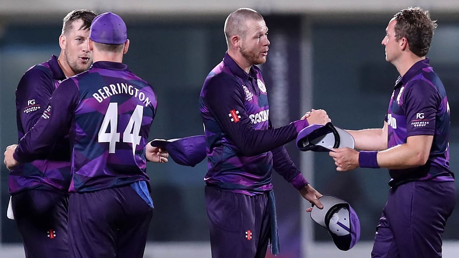 Scotland's players celebrate their win in the ICC men’s Twenty20 World Cup cricket match between Bangladesh and Scotland at the Oman Cricket Academy Ground. Credit: AFP Photo
