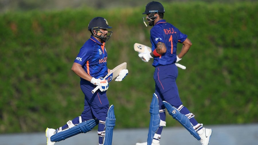 India's Rohit Sharma (L) and KL Rahul take run during a warmup cricket match between India and Australia for the ICC men’s Twenty20 World Cup at the ICC Cricket Academy Ground in Dubai on October 20, 2021. Credit: AFP Photo