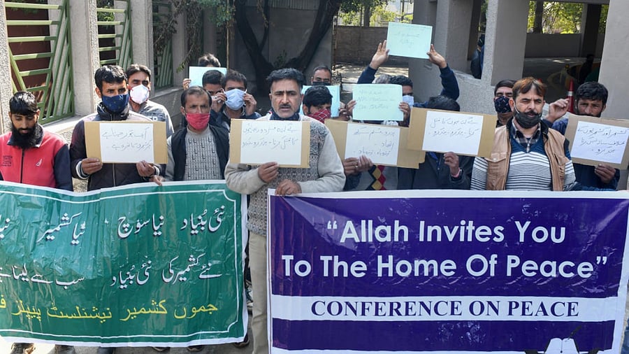Leaders and workers of Jammu and Kashmir Nationlist Front hold banners and placards during a protest against the killing of civilians including non-locals, in Srinagar. Credit: PTI photo