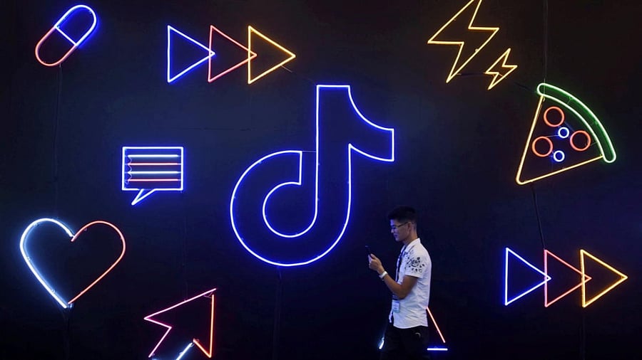 Man walks past a sign of ByteDance's app TikTok. Credit: Reuters Photo
