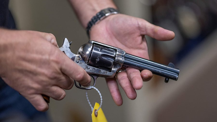 Props expert Guillaume Delouche at Independent Studio Services holds a prop gun while talking about them in Sunland-Tujunga, Los Angeles, California on October 22, 2021. Credit: AFP Photo