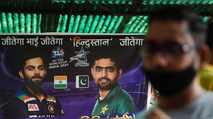 A cricket fan cheers for team India ahead of the India vs Pakistan ICC Men's T20 World Cup match in Dubai, while organising a 'yagya' for the victory of Team India. Credit: PTI Photo