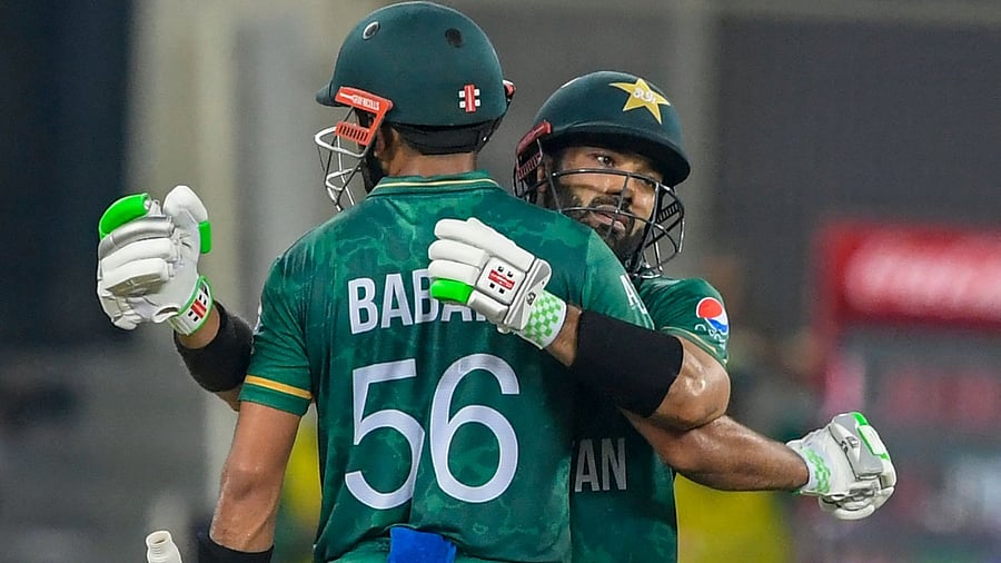 Pakistan's Mohammad Rizwan (R) celebrates with his team captain Babar Azam after scoring a half-century (50 runs) during the ICC men’s Twenty20 World Cup cricket match between India and Pakistan at the Dubai International Cricket Stadium in Dubai on October 24, 2021. Credit: AFP Photo