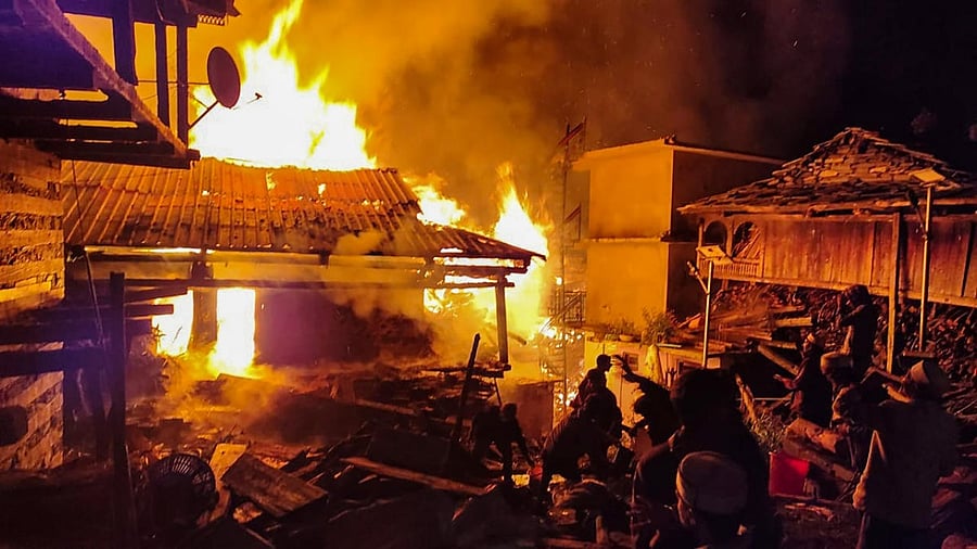 Villagers attempt to douse a fire that broke out at Malana village in Kullu district. Credit: PTI Photo