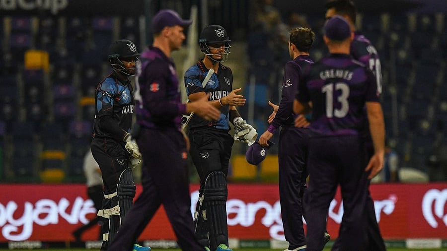 Namibia's and Scotland's cricketers greet each other after the end of play during the ICC men’s Twenty20 World Cup cricket match between Scotland and Namibia at the Sheikh Zayed Cricket Stadium in Abu Dhabi on October 27, 2021. Credit: AFP Photo