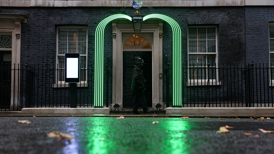 Green light installation is illuminated outside Number 10 Downing Street ahead of the UN Climate Change Conference (COP26) taking place in Glasgow, in London. Credit: Reuters Photo