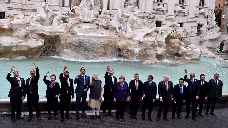 Singapore's Prime Minister Lee Hsien Loong, International Monetary Fund (FMI) Managing director, Kristalina Georgieva, Director General, World Health Organization (WHO), Tedros Adhanom Ghebreyesus, Spanish Prime Minister Pedro Sanchez, Indian Prime Minister Narendra Modi, Australian Prime Minister Scott Morrison, German Chancellor Angela Merkel, Italian Prime Minister Mario Draghi, French President Emmanuel Macron, British Prime Minister Boris Johnson, Director general, Food and Agriculture Organization (FAO), Qu Dongyu, President of the European Council Charles Michel, and Japan's senior deputy foreign minister for economic affairs, Hiroshi Suzuki throw a coin in the water during a visit to the Trevi fountain in central Rome on October 31, 2021 on the sidelines of the G20 of World Leaders Summit. Credit: AFP Photo