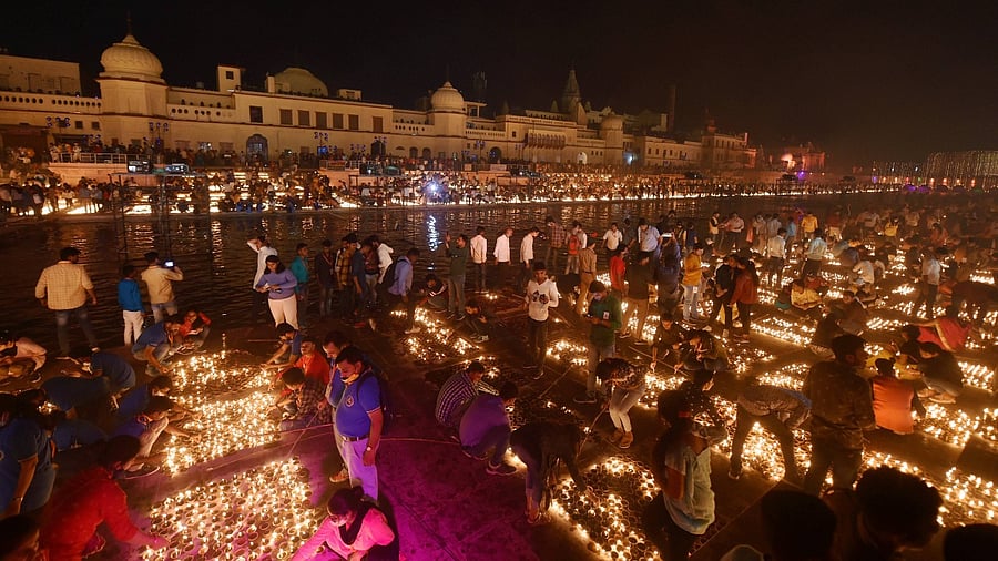 Devotees light earthen lamps on the bank of Saryu River during Deepotsav celebrations in Ayodhya last year. Credit: PTI Photo