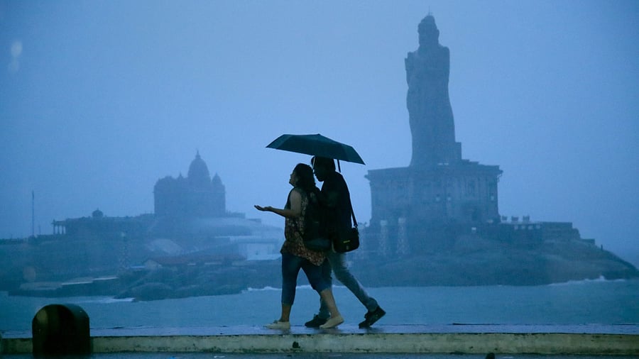 Pedestrians during heavy rain in Kanyakumari, Saturday, Oct. 30, 2021. Credit: PTI Photo