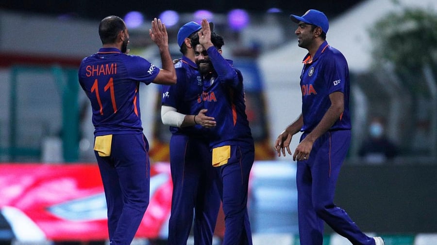Rohit Sharma celebrates with teammates after taking the wicket of Afghanistan's Mohammad Nabi. Credit: Reuters photo