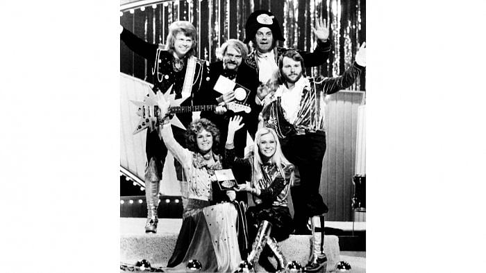 ABBA hold the trophy as they celebrate on stage after winning the final of the Eurovision Song Contest 1974. Credit: AFP File Photo