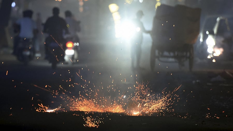 People burn firecrackers to celebrate Diwali festival, in New Delhi. Credit: PTI Photo