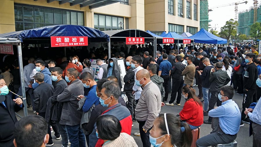 People line up for Nucleic acid testing at a hospital following new cases of Covid-19 in China. Credit: Reuters photo