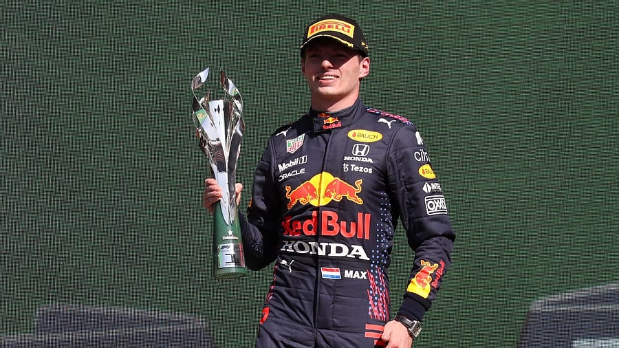 Red Bull's Max Verstappen celebrates on the podium after winning the Mexico Grand Prix. Credit: Reuters Photo
