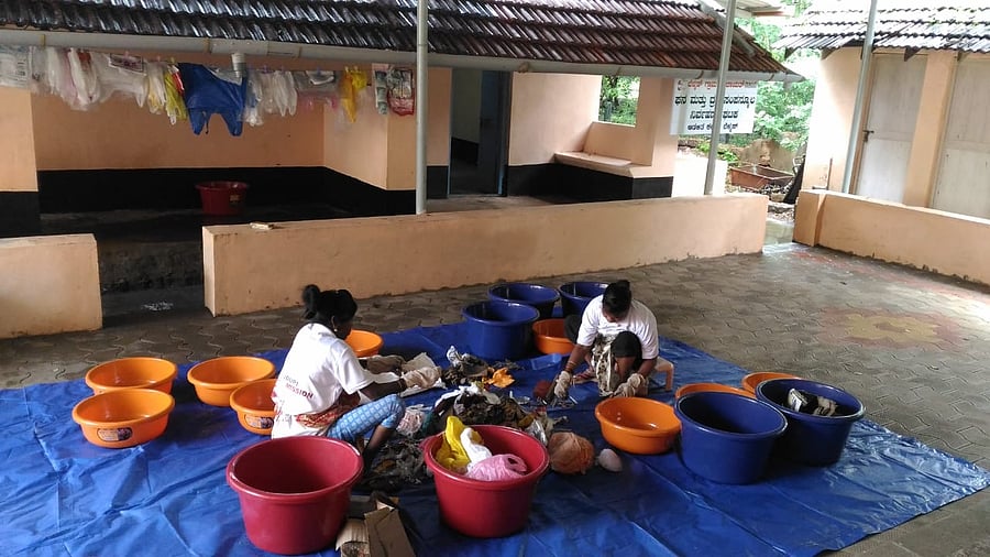 Women volunteers partake in a solid waste management drive. Credit: DH File Photo
