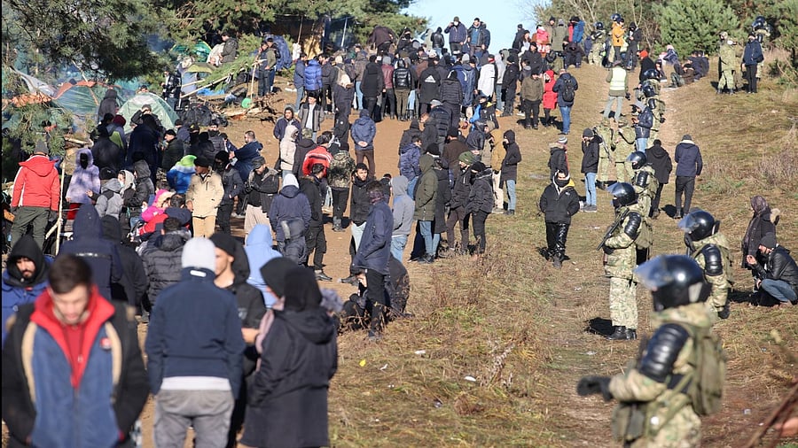 Migrants gather on the Belarusian-Polish border in an attempt to cross it in the Grodno region, Belarus. Credit: Reuters Photo