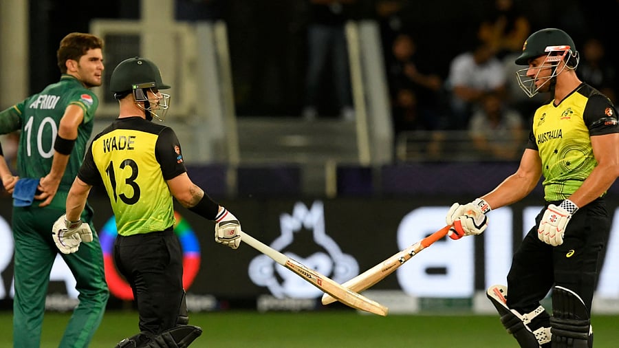 Australia's Matthew Wade (C) and Marcus Stoinis celebrate after a six. Credit: AFP Photo