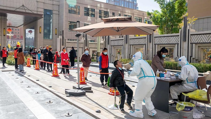 Medical workers take swab samples from residents to be tested for the Covid-19 coronavirus, in Ganzhou District, in Zhangye, in China's northwest Gansu province. Credit: AFP PhotoIANS