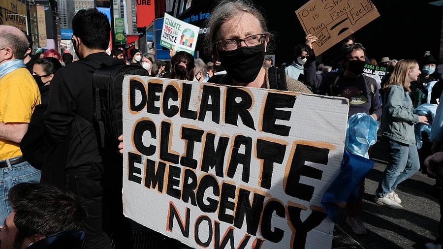 Hundreds of climate protesters walk from Times Square to New York Governor Kathy Hochul’s office to demand more action against climate change on on November 13, 2021 in New York City. The protesters, representing a cross section of environmental groups, are demanding that New York State do more to pass legislation that will hold major companies with a history of polluting accountable. Credit: PTI Photo
