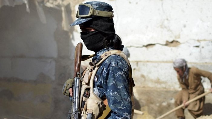 A Taliban member stands guard in front of the rubble of a suspected Islamic State hideout following an operation against Islamic State-Khorasan, the local chapter of the jihadist group, started a night before, in Kandahar. Credit: AFP photo