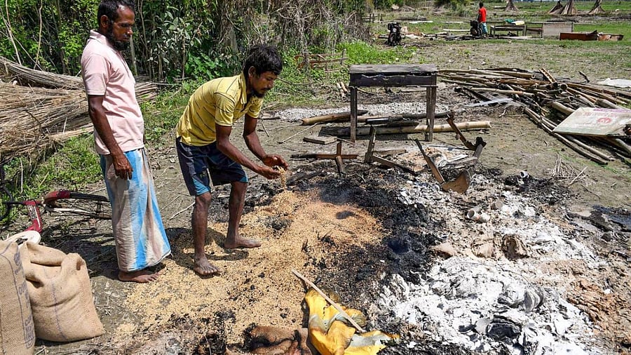 People search for their belongings after their houses were demolished during an eviction drive, in Darrang district. Credit: PTI Photo