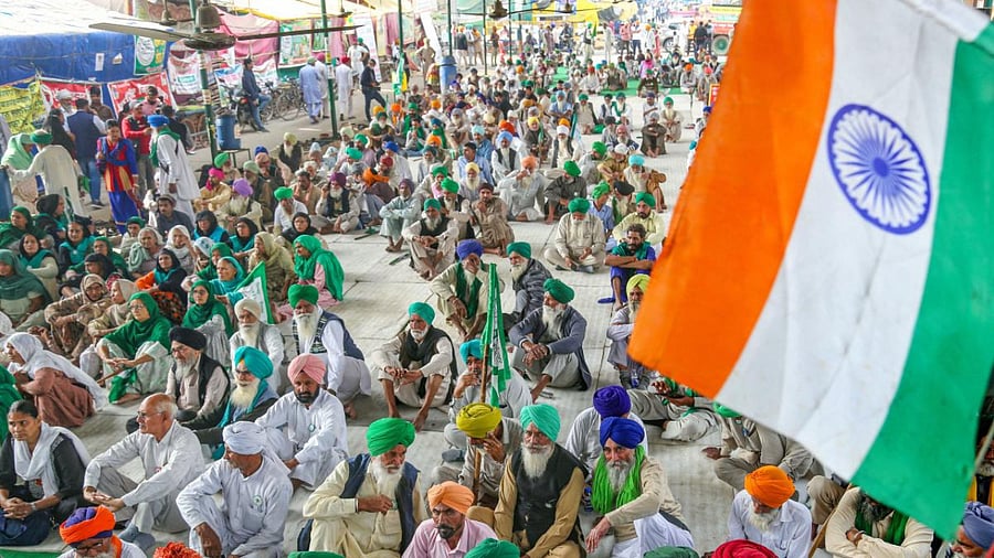 The national flag flutters as farmers celebrate after Prime Minister Narendra Modi announced the repealing of the three farm reform laws, at Tikri Border in New Delhi. Credit: PTI Photo