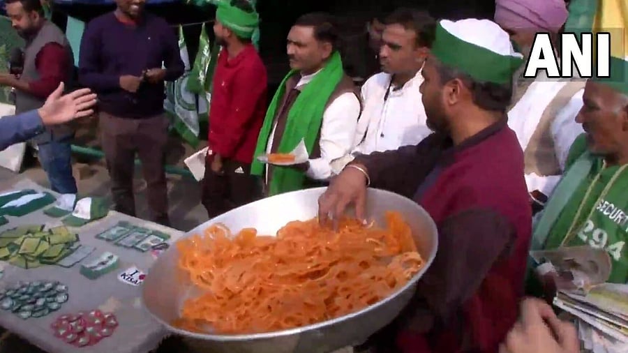 Sweets are distributed at Delhi borders. Credit: ANI Photo