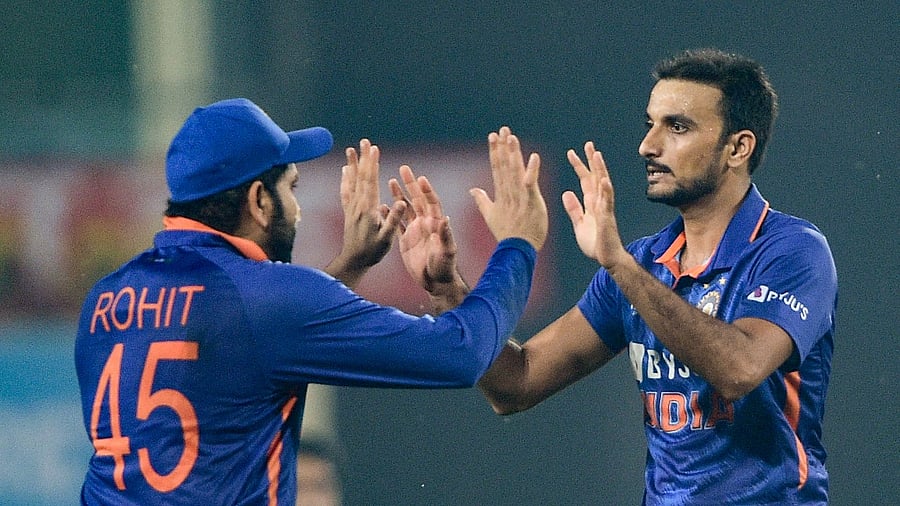 Harshal Patel being greeted by his skipper Rohit Sharma after dismissing New Zealand batsman Glenn Phillips. Credit: PTI Photo
