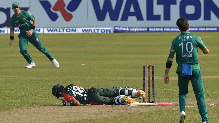 Bangladesh's Afif Hossain (C) lies on the ground after he was hit by the ball as Pakistan's Shaheen Shah Afridi (R) watches during the second Twenty20 international cricket match between Bangladesh and Pakistan. Credit: AFP Photo