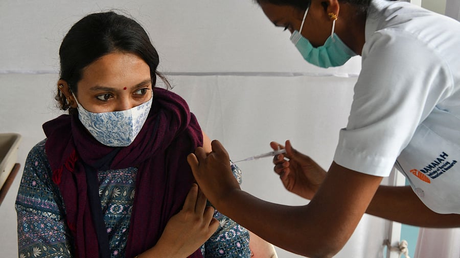 A medical staff inoculates a woman with a dose of the Covishield vaccine. Credit: AFP Photo