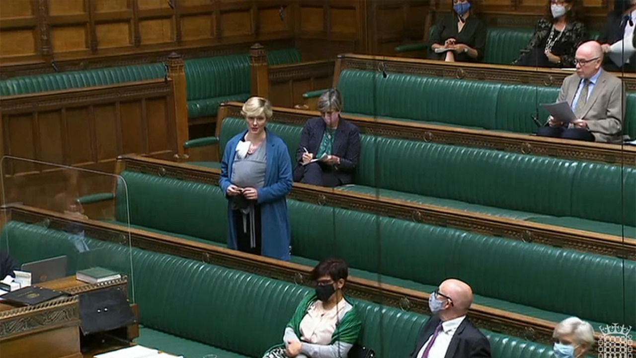 File Photo shows British Labour MP Stella Creasy speaking with her newborn baby strapped to her in the chamber of the House of Commons in London. Credit: AFP Photo