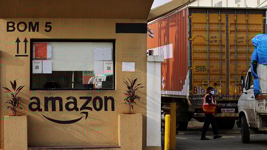 A man inspects trucks before they enter an Amazon storage facility. Credit: Reuters Photo