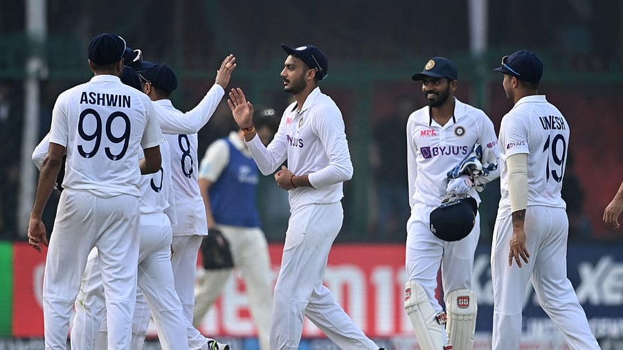s Axar Patel (C) walks back to the pavilion along with his teammates. Credit: AFP Photo