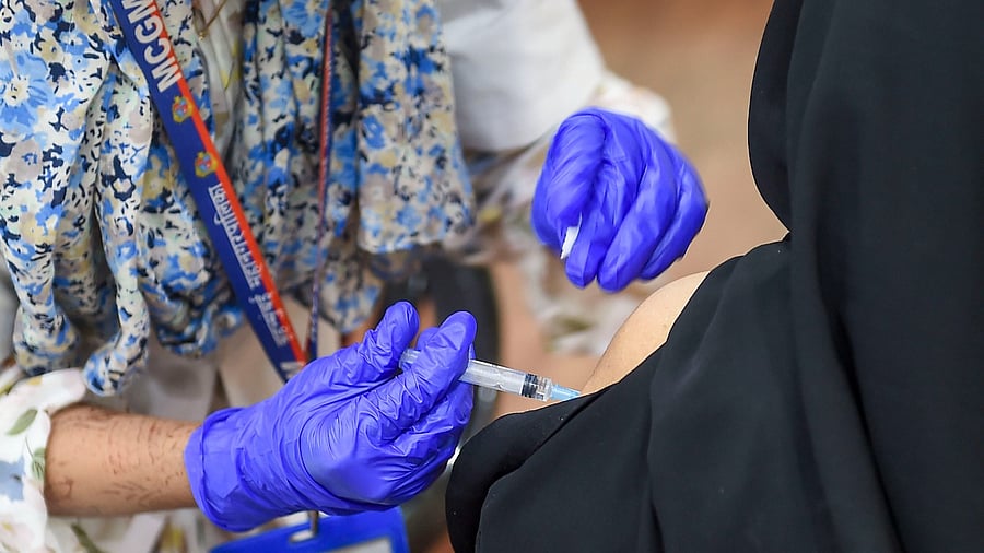 A health worker inoculates a beneficiary with a dose of Covid-19 vaccine at SIES college, Sion in Mumbai. Credit: PTI Photo