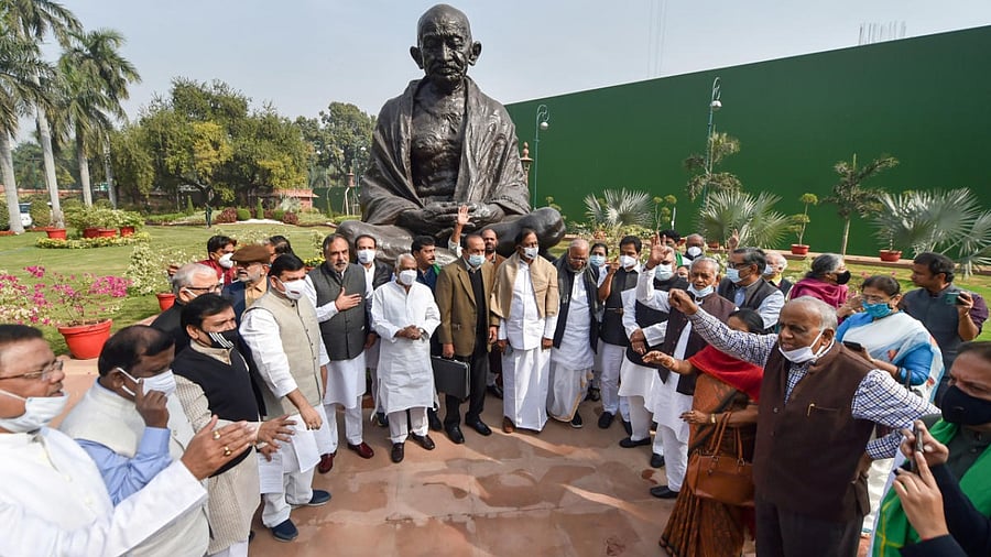 Opposition leaders protest near Mahatma Gandhi's statue over suspension of 12 Rajya Sabha MPs during the Winter Session of Parliament. Credit: PTI Photo