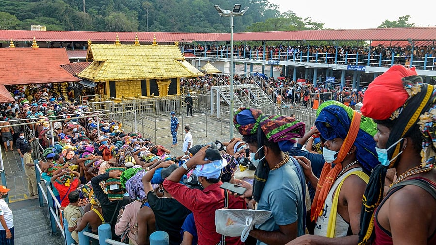 Devotees stand in a queue to visit the Sabarimala Temple. Credit: PTI Photo