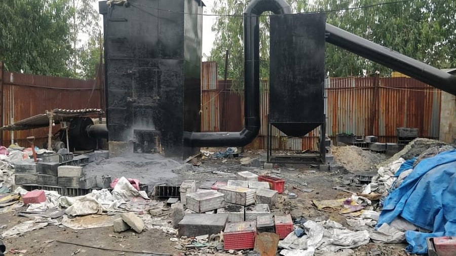 KSPCB officials seal a lead acid battery processing unit on Thursday. Credit: DH Photo