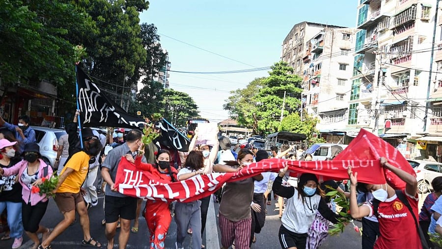 Protesters taking part in a demonstration against the military coup run as security forces launched a crackdown on the protest in Yangon. Credit: AFP Photo