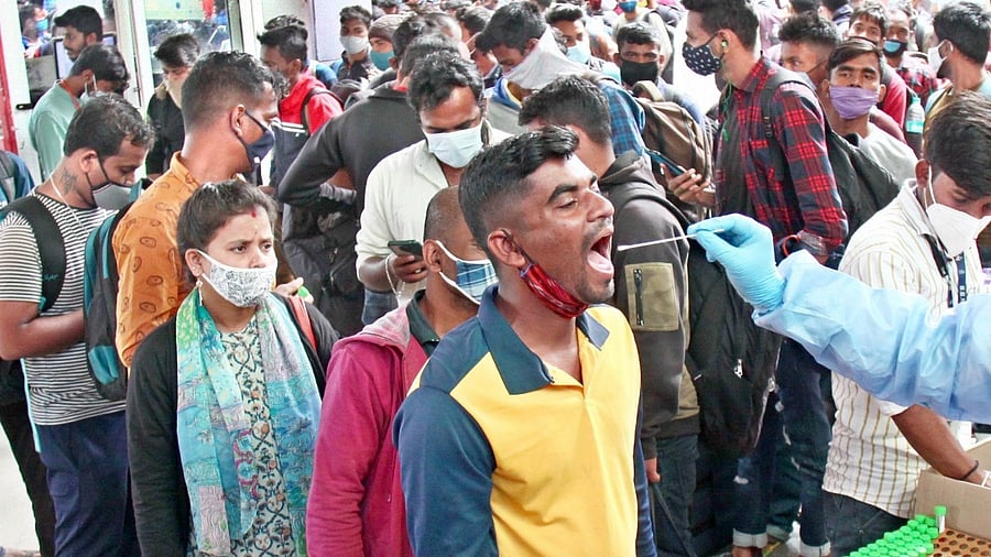 Health workers collect swab samples for Covid-19 tests for outstation passengers at Majestic Bus Stand. Credit: IANS Photo