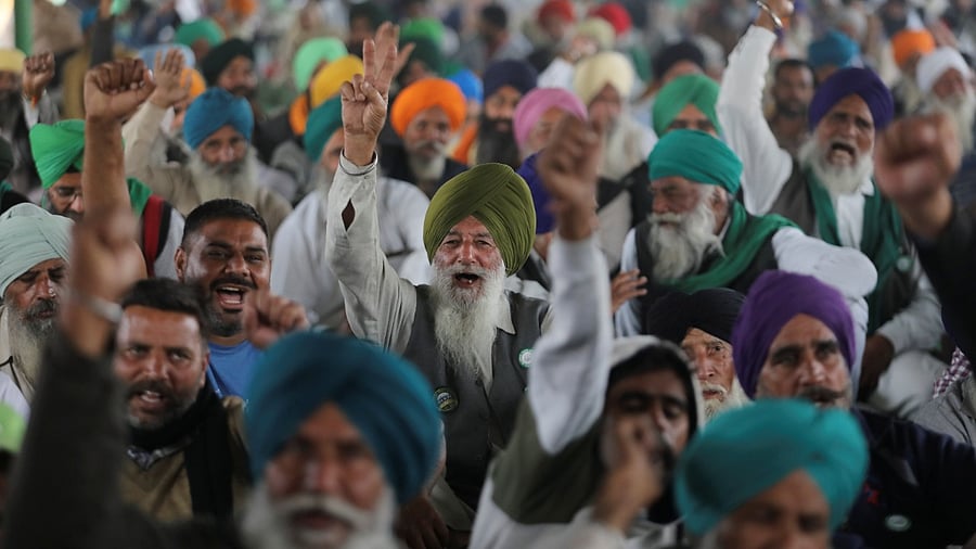 Farmers celebrate after protests were called off at Delhi-Haryana border. Credit: Reuters Photo