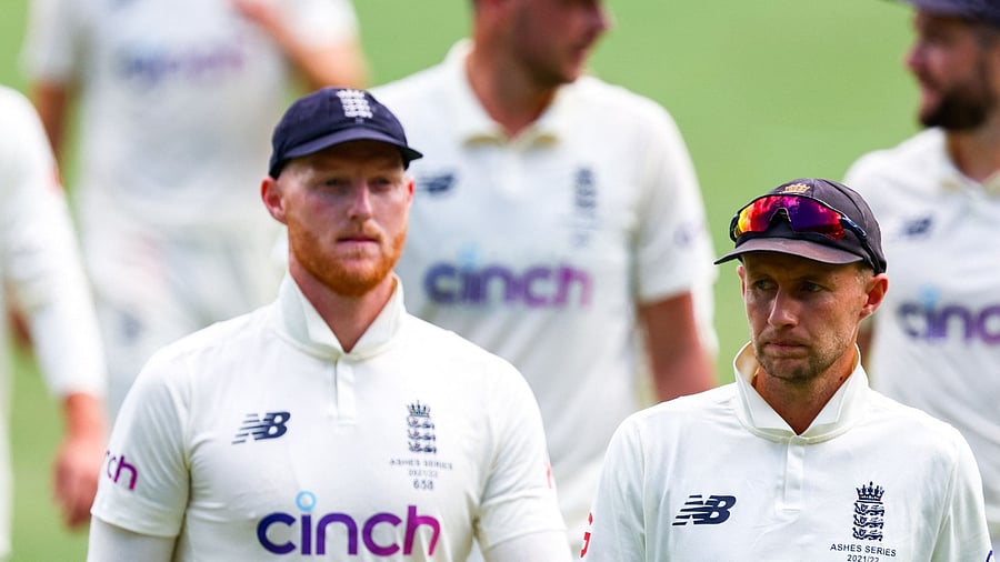 Ben Stokes (L) and Joe Root (R) walk off at the conclusion of the first Ashes cricket Test match. Credit: AFP Photo