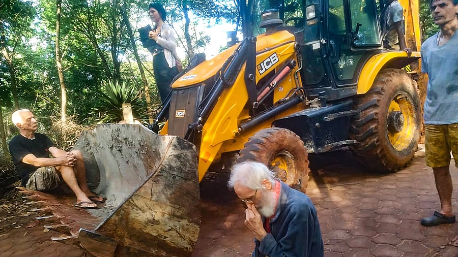 Locals sit on a protest against Auroville Foundation's road laying project which requires cutting of several trees, at Auroville in Villupuram district, Thursday, December 9, 2021. Credit: PTI Photo