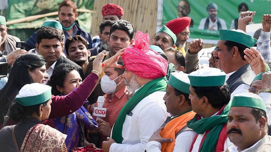 BKU leader Rakesh Tikait with others farmers celebrates as they prepare to leave for their homes from the Ghazipur border after the year-long agitation against contentious farm reform laws, in New Delhi, Saturday. Credit: PTI Photo