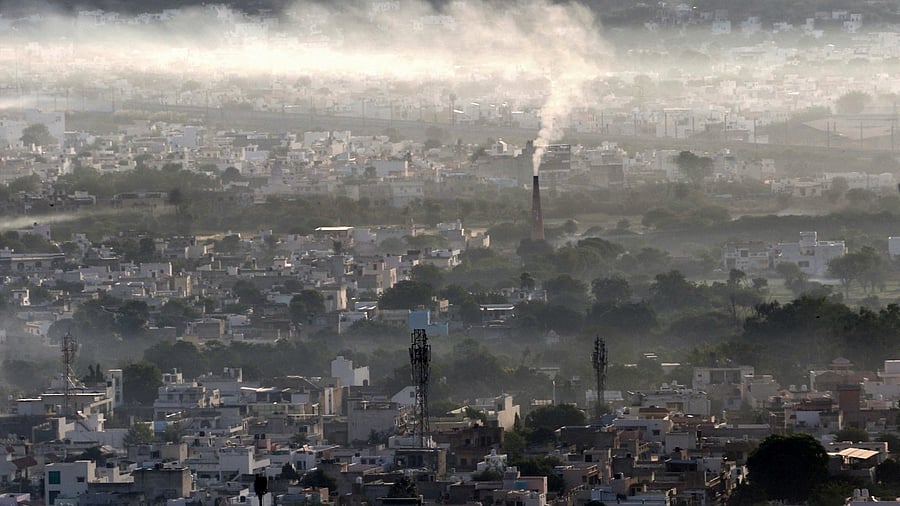 Smoke billows from a factory chimney during a smoggy morning in Ajmer. Credit: AFP File Photo