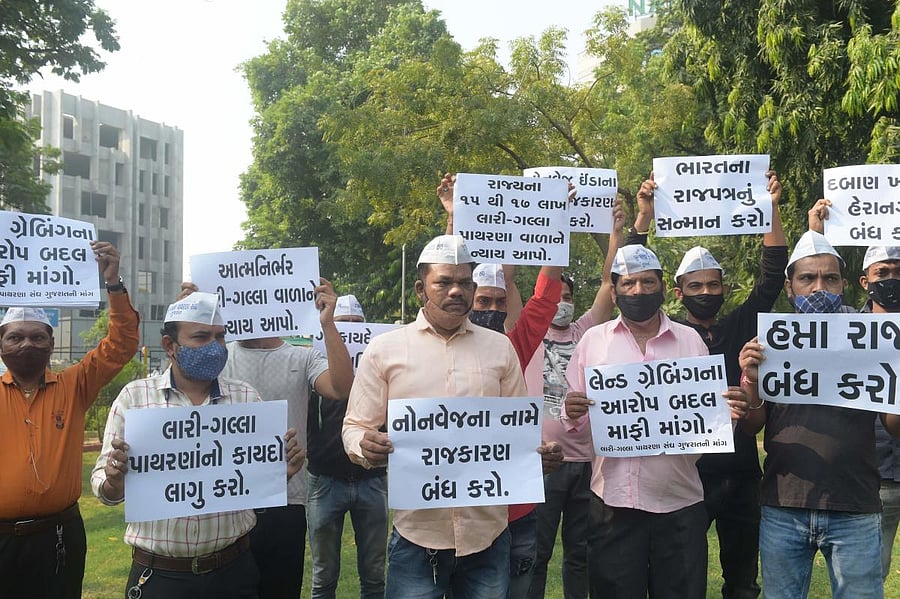 Street vendors hold placards as they protest after authorities ordered to remove stalls selling non-vegetarian food items from main roads, in Ahmedabad. Credit: AFP Photo